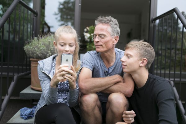 Vater mit Sohn und Tochter mit Smartphone